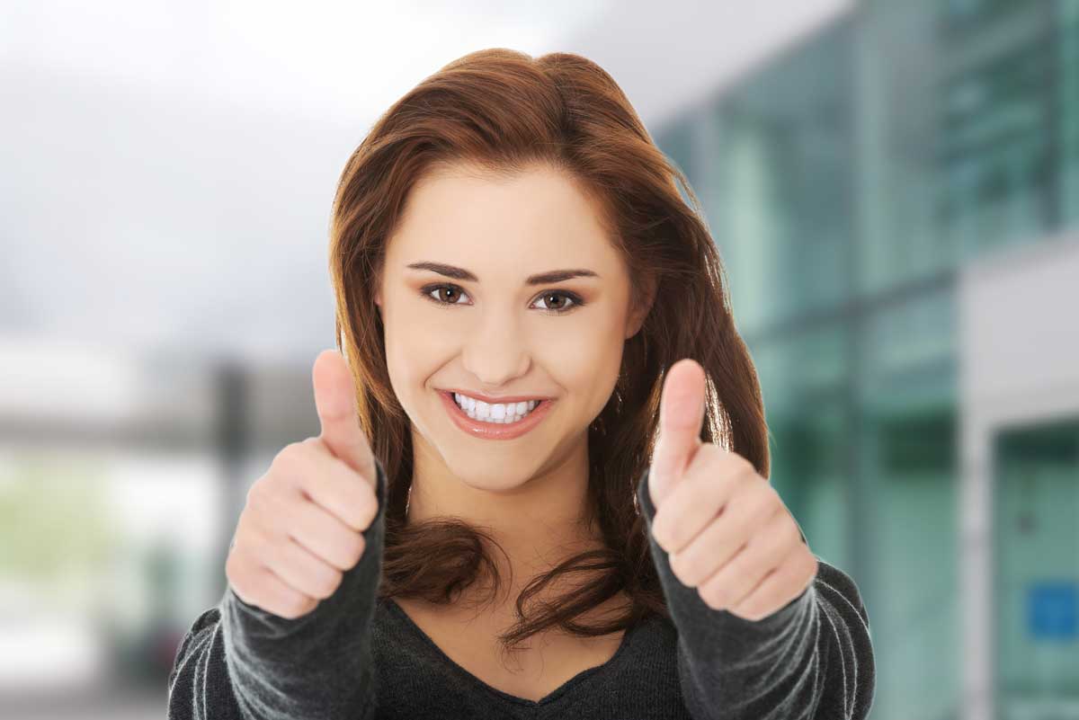 Happy smiling woman with thumbs up