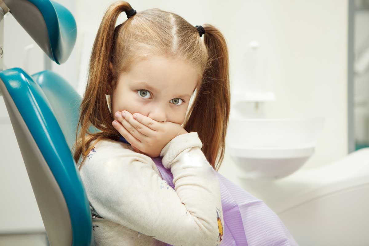 Little child at dentist office in comfortable chair